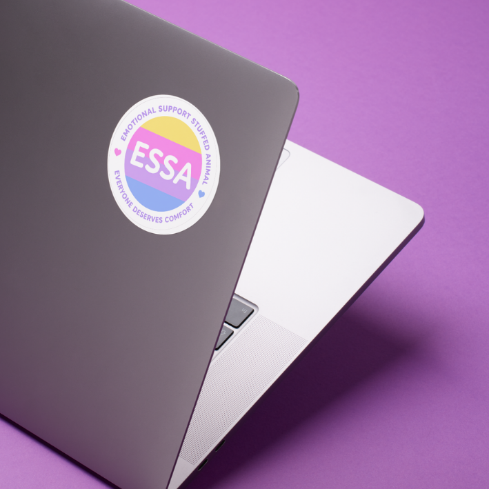 A circular ESSA sticker applied to the lid of a dark gray laptop, set against a solid purple background.