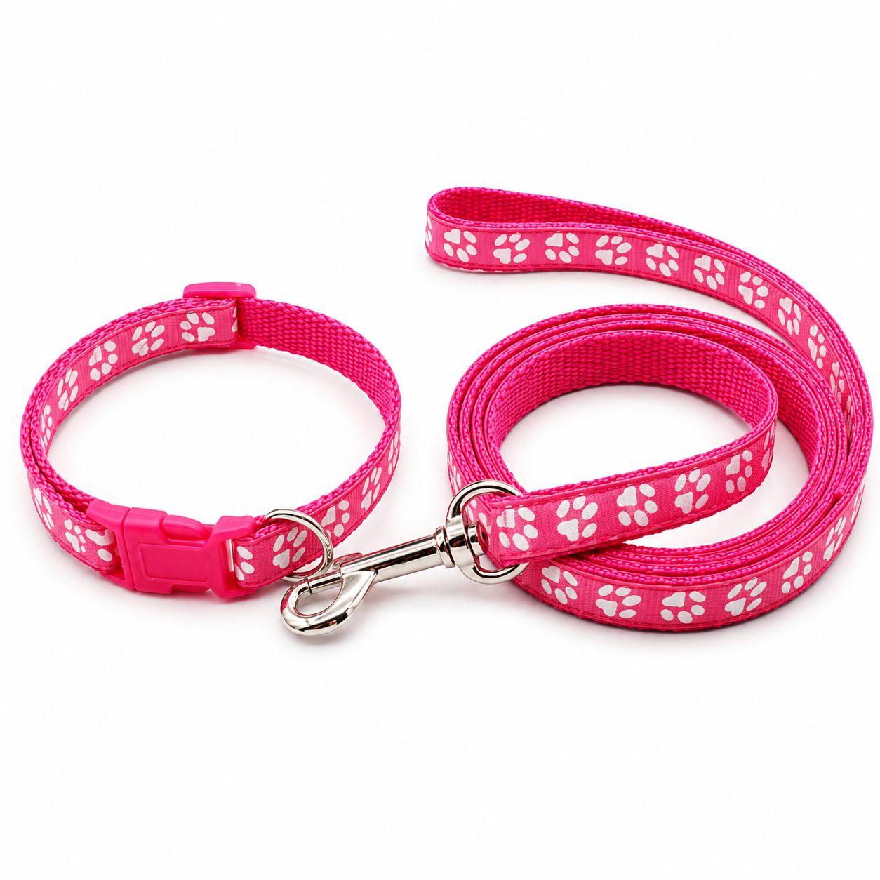 A pink pet collar and matching leash set with white paw print patterns, shown on a clean white background.
