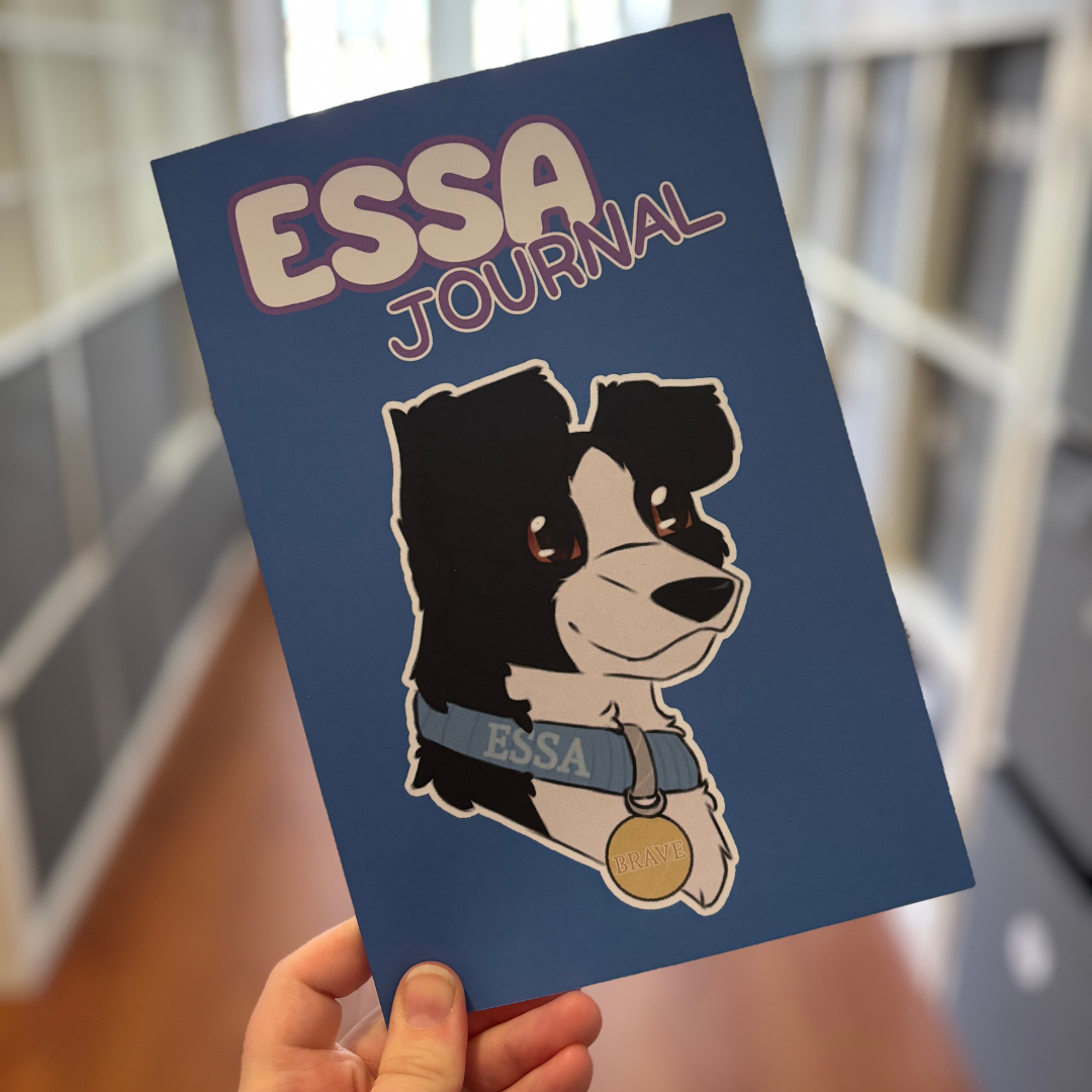 Blue notebook with a dog illustration and 'ESSA' branding held by a person.