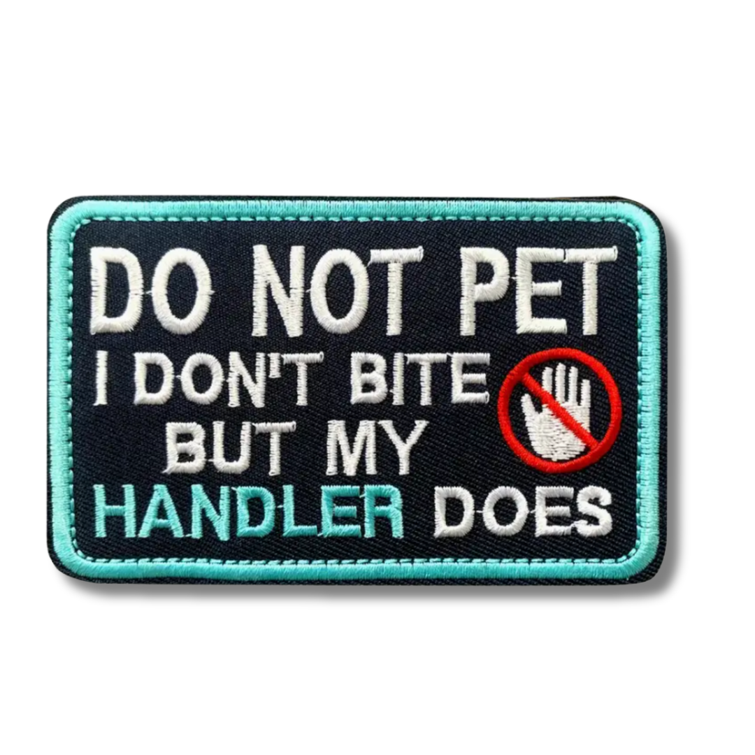 Embroidered patch with text 'Do not pet, I don't bite but my handler does' on a black background.