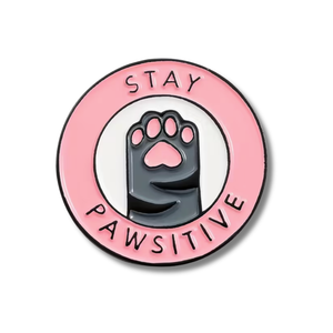 Enamel pin with paw print and 'Stay Pawsitive' text on a pink circle