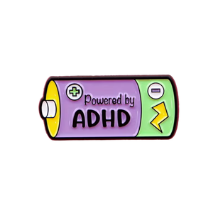 Battery-shaped pin with 'Powered by ADHD' text on a white background