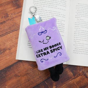 Purple plush bookmark with text on an open book