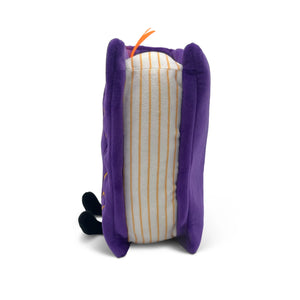 A plush toy shaped like a sandwich, featuring purple plush outer layers, a cream-colored center with thin orange stripes, and small black feet at the bottom, shown on a white background.