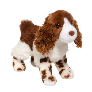 Plush toy dog with brown and white fur on a white background