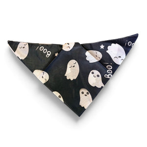 A patterned pet bandana with a black and white ghost design.