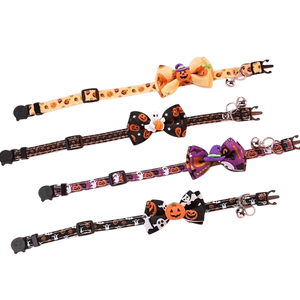 Four Halloween-themed pet collars arranged diagonally on a white background, each featuring a decorative bow and printed patterns of pumpkins, skulls, ghosts, and spiderwebs.