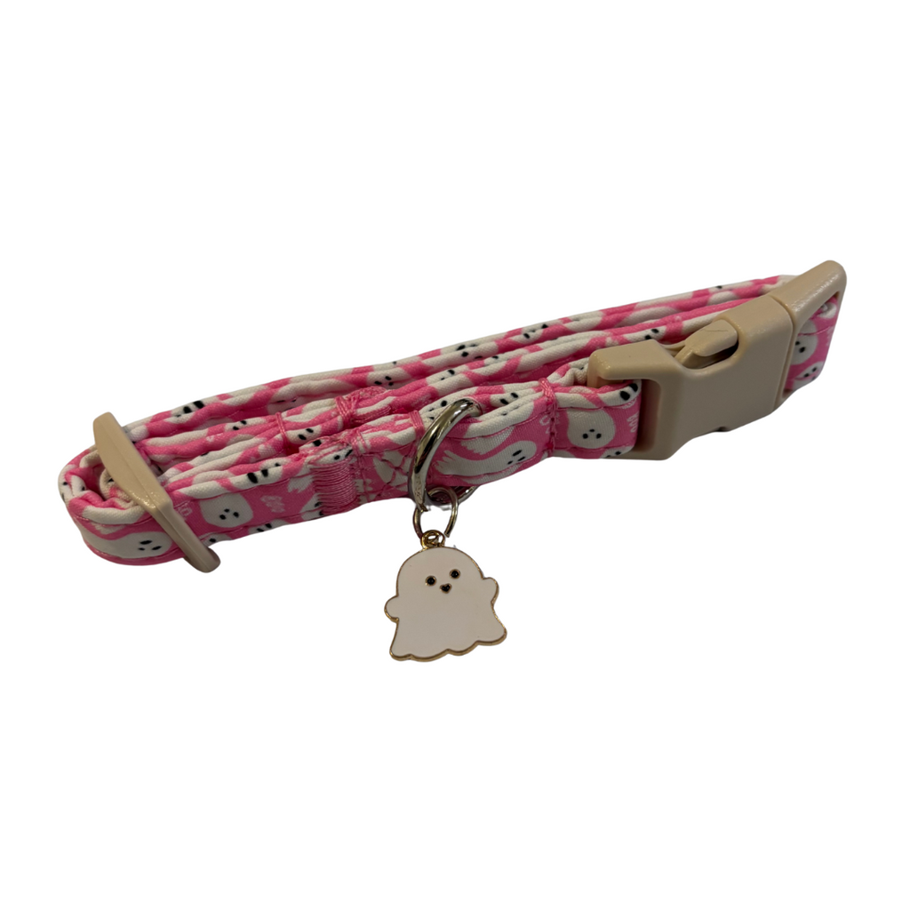 Pink and white patterned dog collar with a beige buckle and ghost charm on a white background