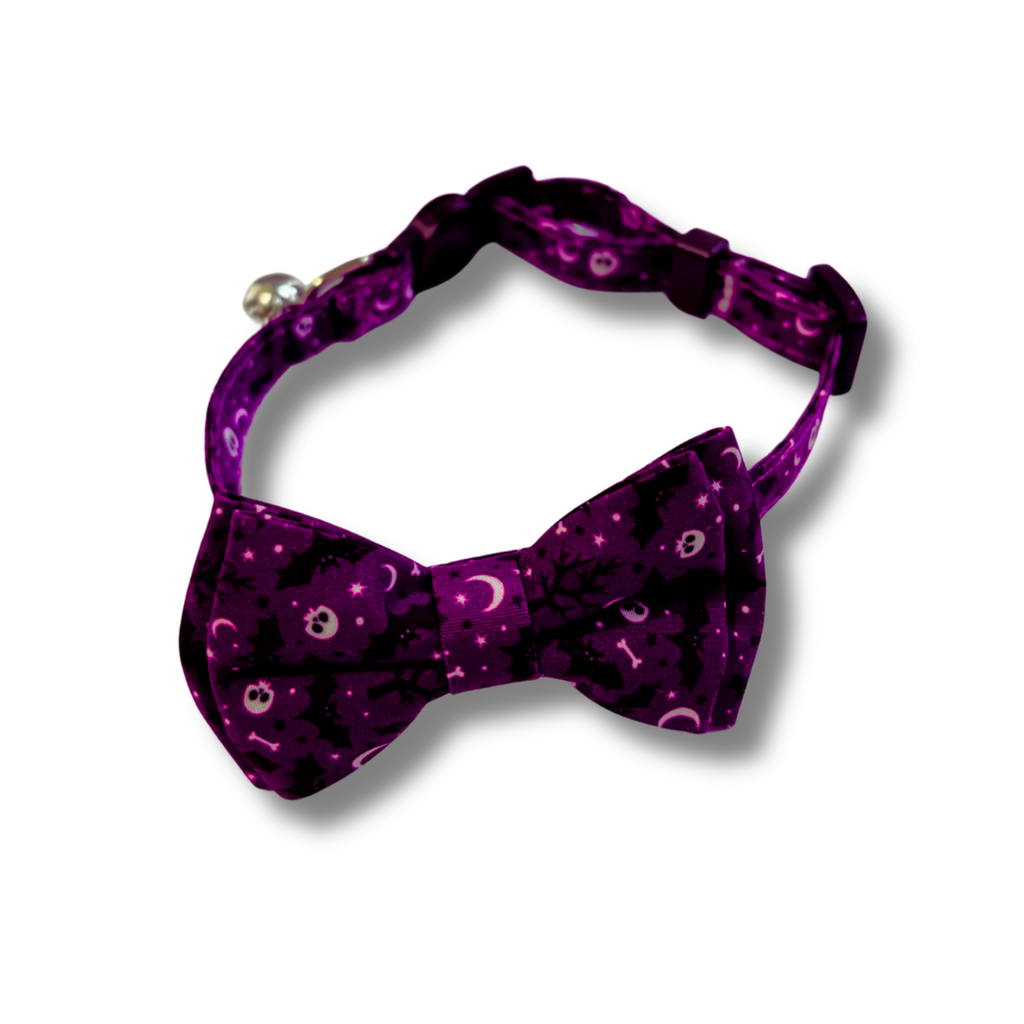 Purple bow tie with celestial pattern on a white background