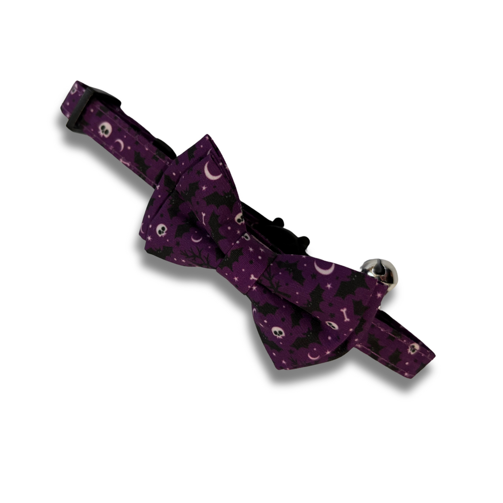 Purple dog collar with black cat pattern on a white background