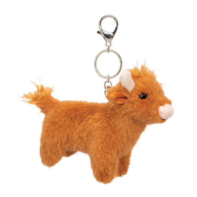 Plush cow keychain with a metal clip on a white background