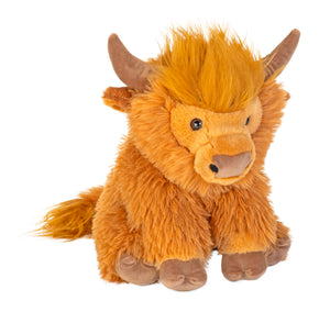 A plush highland cow toy with shaggy golden-brown fur, brown horns, and a soft pinkish-brown snout, photographed on a plain white background.