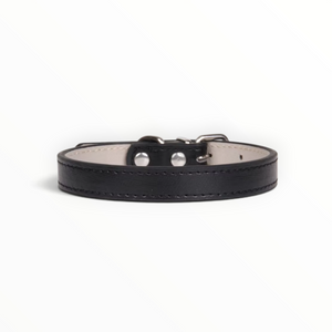 A black leather collar with silver-tone metal hardware and a light beige interior lining, shown against a plain white background.