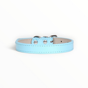 A light blue faux leather dog collar with silver metal hardware, displayed on a clean white background.