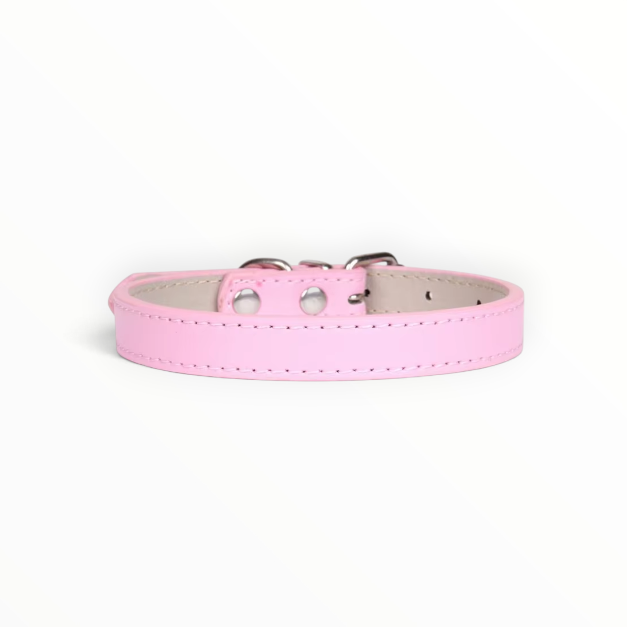 A light pink faux leather dog collar with silver metal hardware, shown on a clean white background.