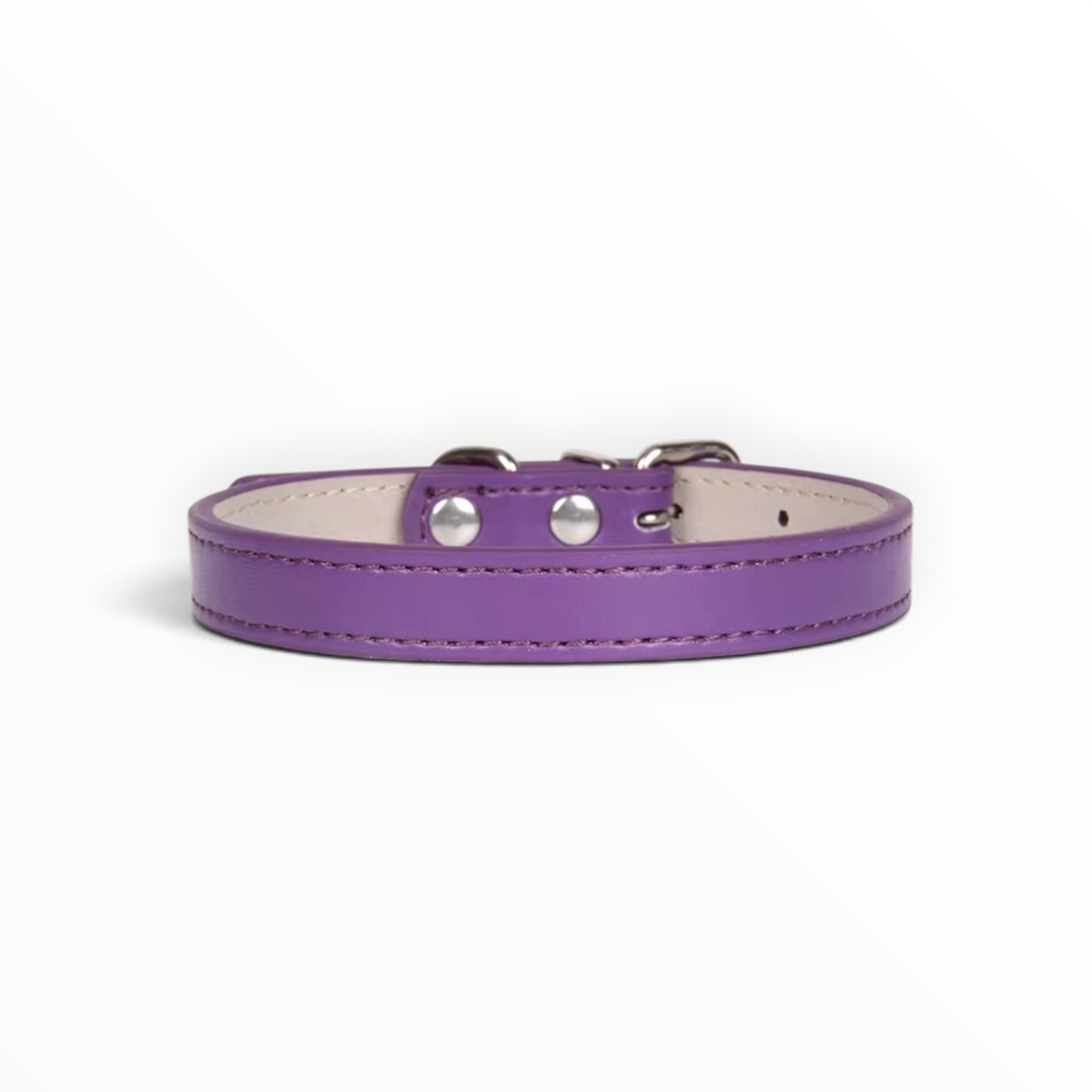A purple leather dog collar with silver-tone metal hardware and a light beige interior, shown on a clean white background.