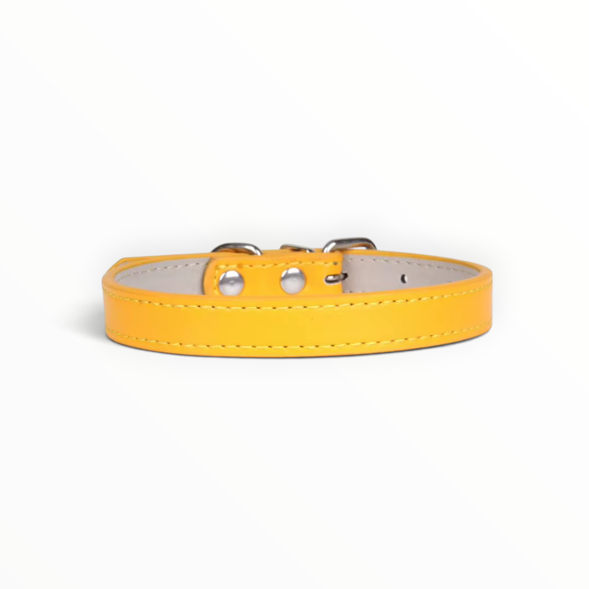 A yellow leather dog collar with silver metal hardware and white stitching, shown against a plain white background.