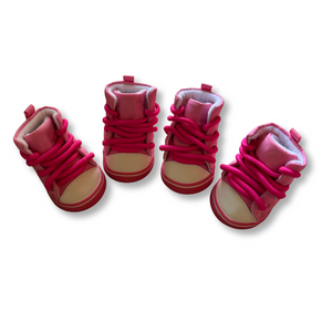 Set of pink children's shoes on a white background