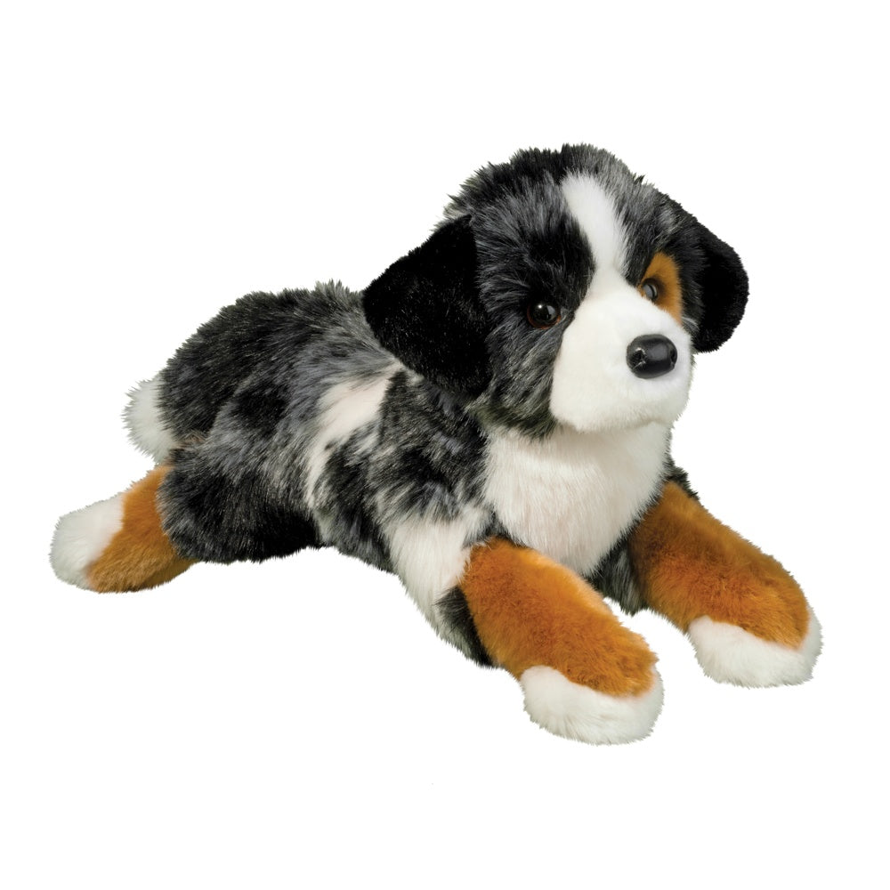 Plush toy dog with black, white, and brown fur on a white background