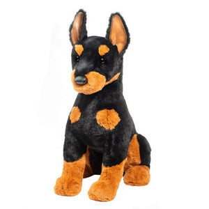 Plush toy dog with black and brown color pattern on a white background