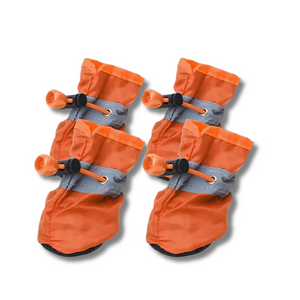 Set of four orange pet boots with gray straps on a white background