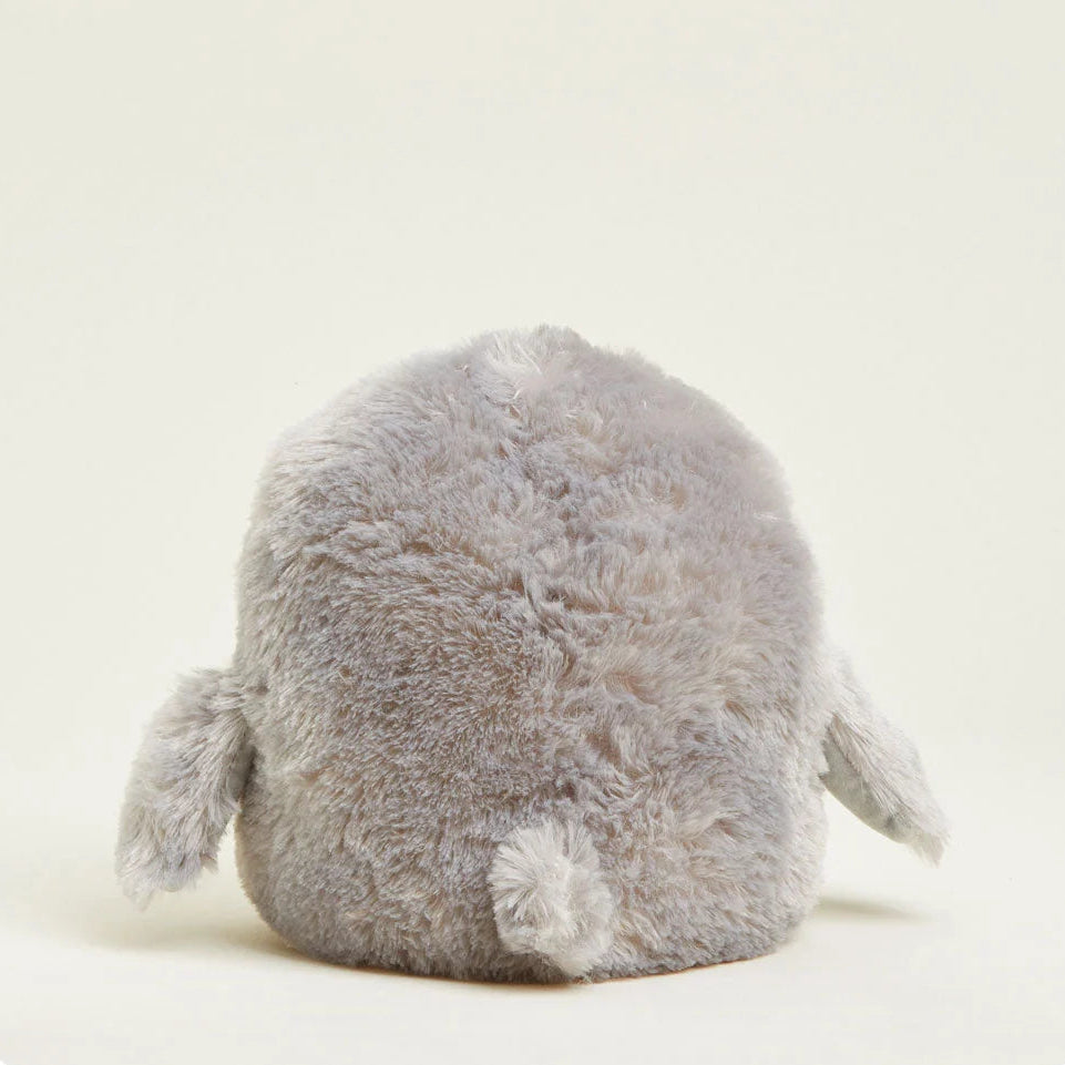 Plush toy resembling a penguin on a light beige background