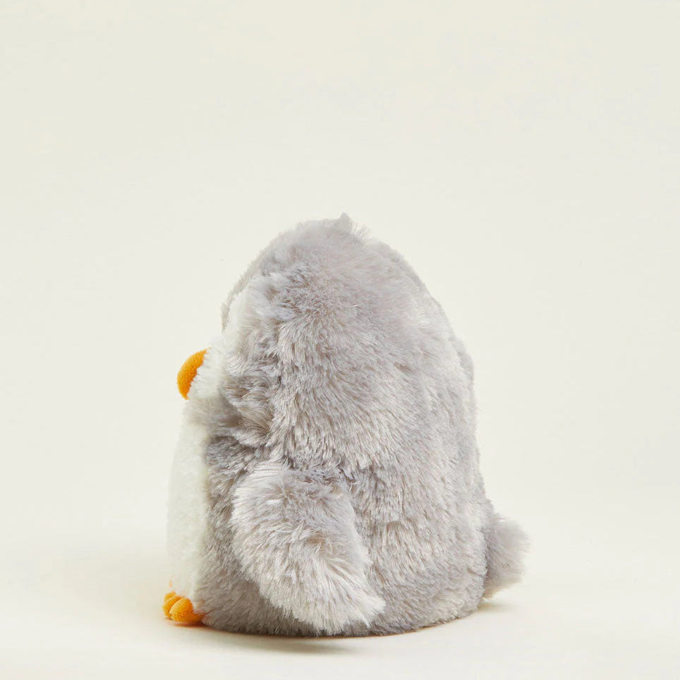 Plush toy penguin on a light beige background