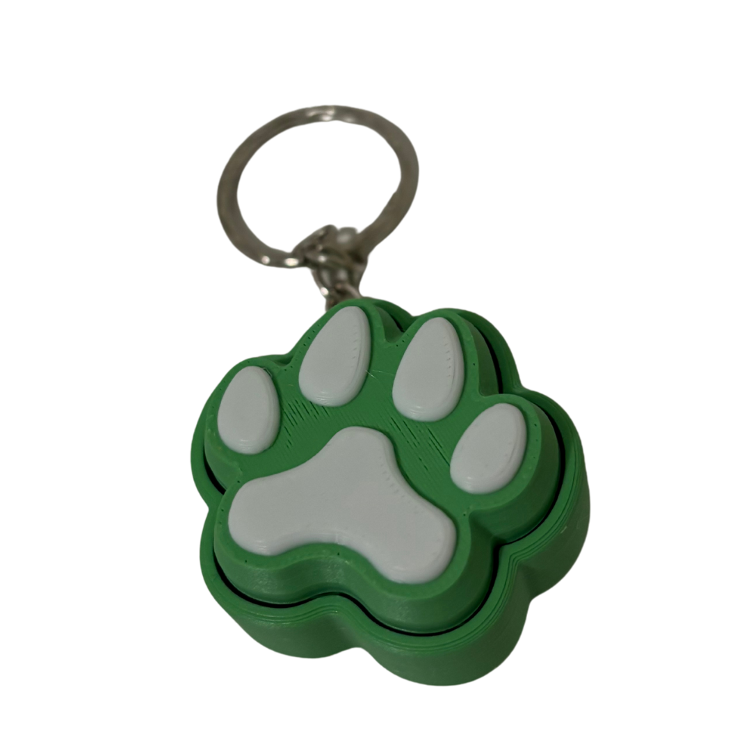 Green and gray paw-shaped keychain on a white background