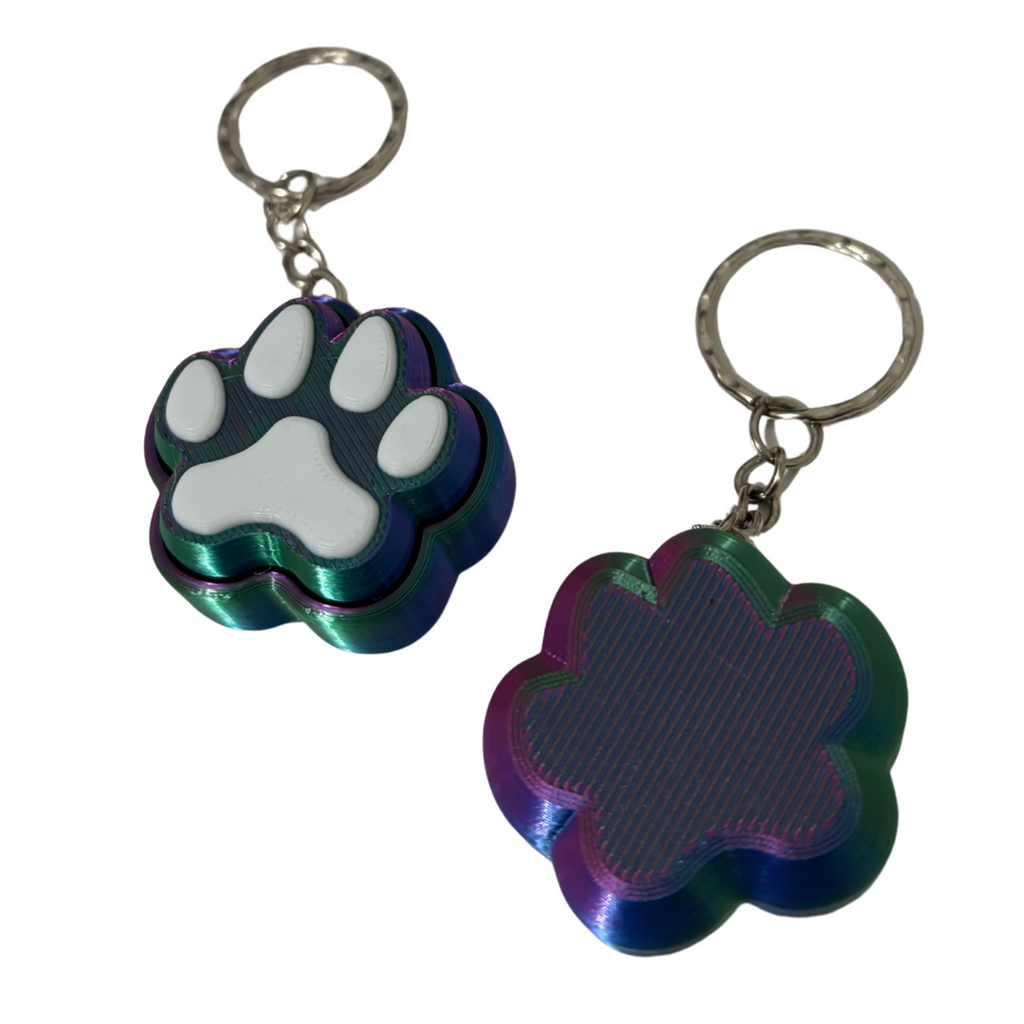 Two keychains with paw print designs on a white background