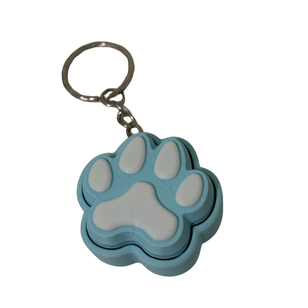 Blue and gray paw-shaped keychain on a white background