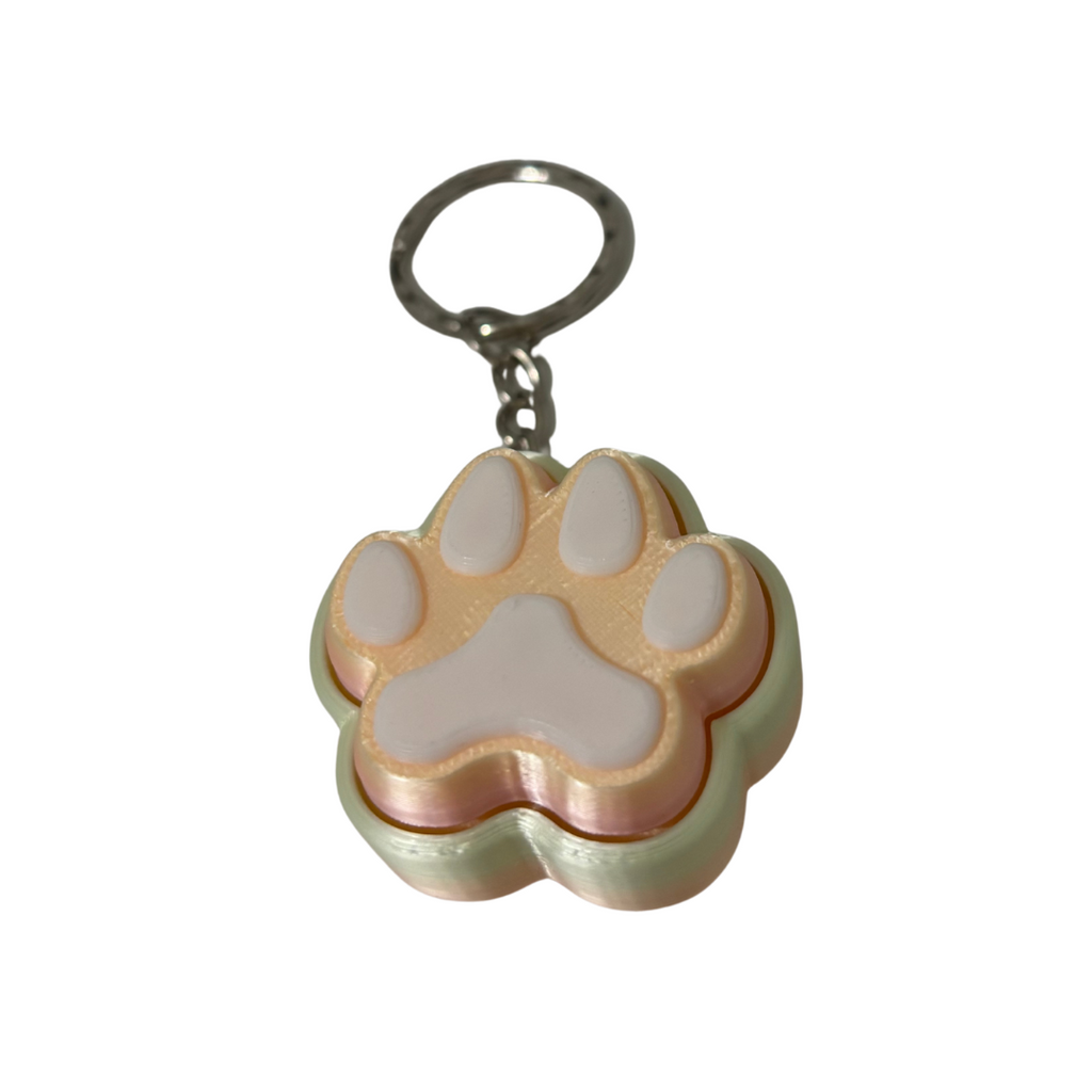 Keychain with a paw print design on a white background