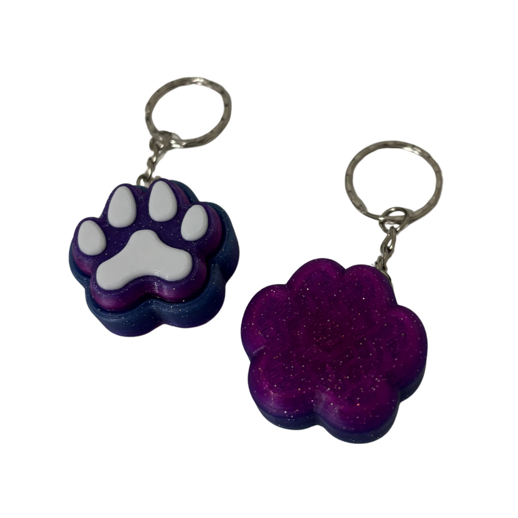 Two purple paw-shaped keychains on a white background