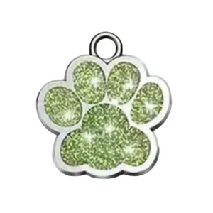 Paw print charm with green glittery center on a white background
