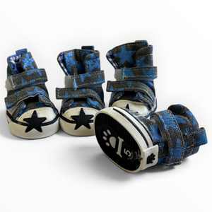 Three blue and black patterned pet boots with white soles and black star details, arranged on a clean white background.