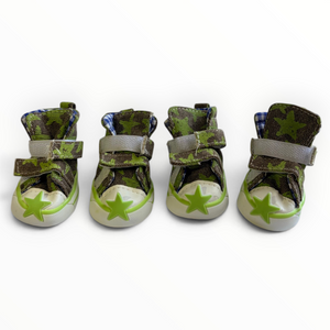 Four green camouflage high-top baby shoes with gray velcro straps and lime green star details on the toes, arranged in a row against a white background.