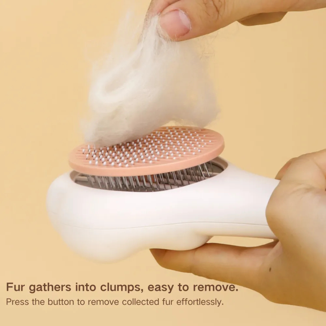 Handheld grooming brush with fur removal feature on a beige background