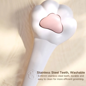 White and pink dental tool with text about stainless steel teeth and washability on a beige background