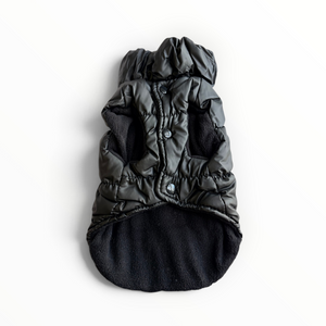 A black puffer-style pet coat with a hood and soft fleece lining, laid flat on a white background.