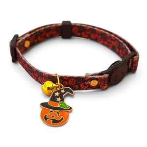 A black and red pet collar with a pumpkin pattern, featuring a white jack o lantern charm with a witch's hat and a small gold bell, shown on a white background.
