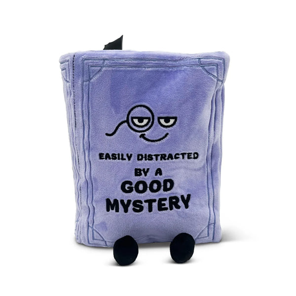 Plush toy resembling a book with text and a face on a white background