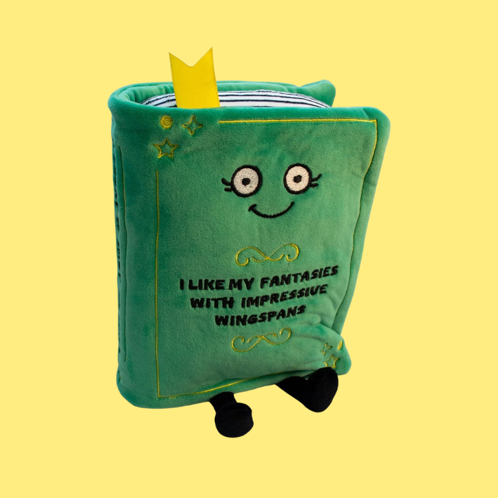 Green plush book on a yellow background