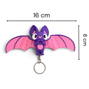 A small bat-shaped keychain with pink wings and a purple body, shown on a white background with measurement lines indicating 16 cm width and 8 cm height.