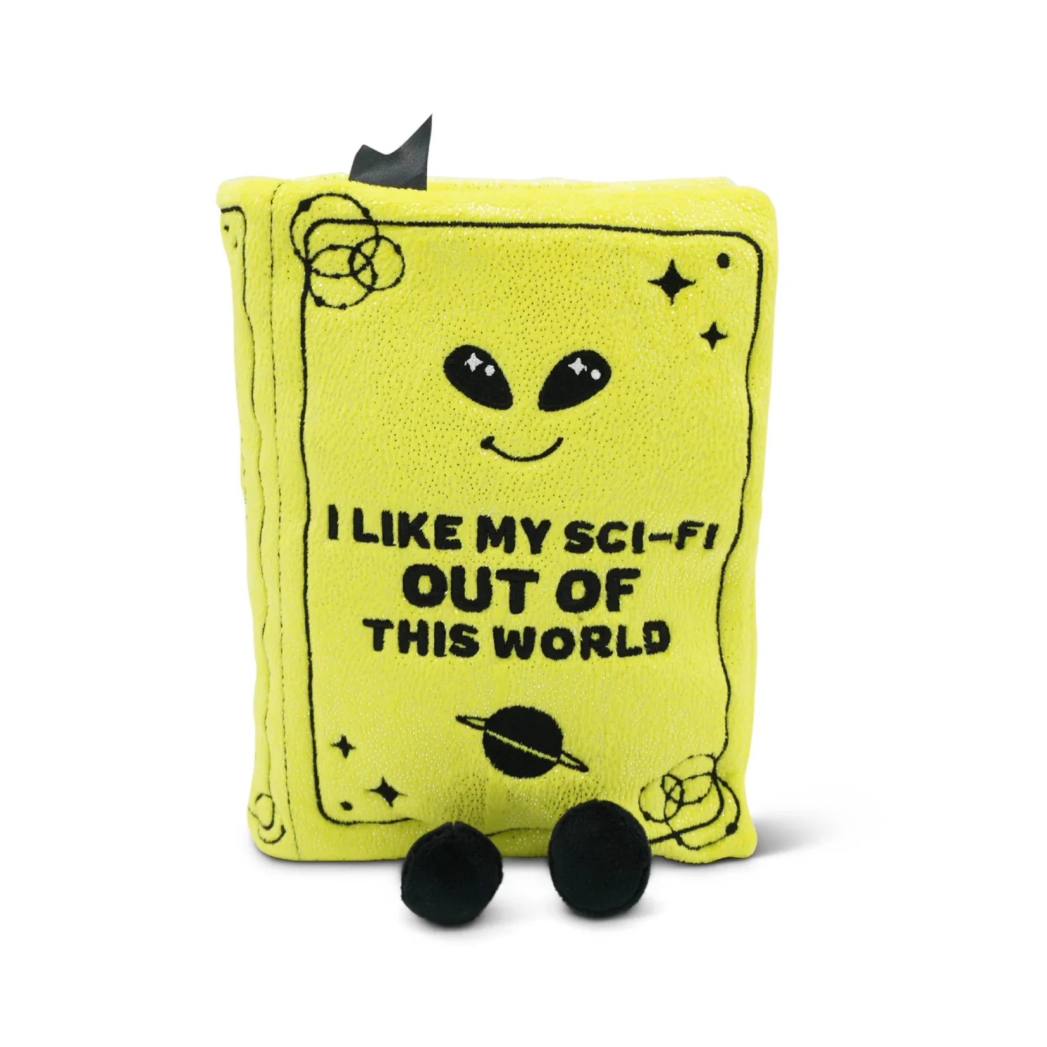 A bright yellow plush book-shaped pouch with black embroidered details, including an alien face, stars, a ringed planet, and the text 'I LIKE MY SCI-FI OUT OF THIS WORLD'. Two black pom-pom feet are attached at the bottom, and a black ribbon is tied to the top.