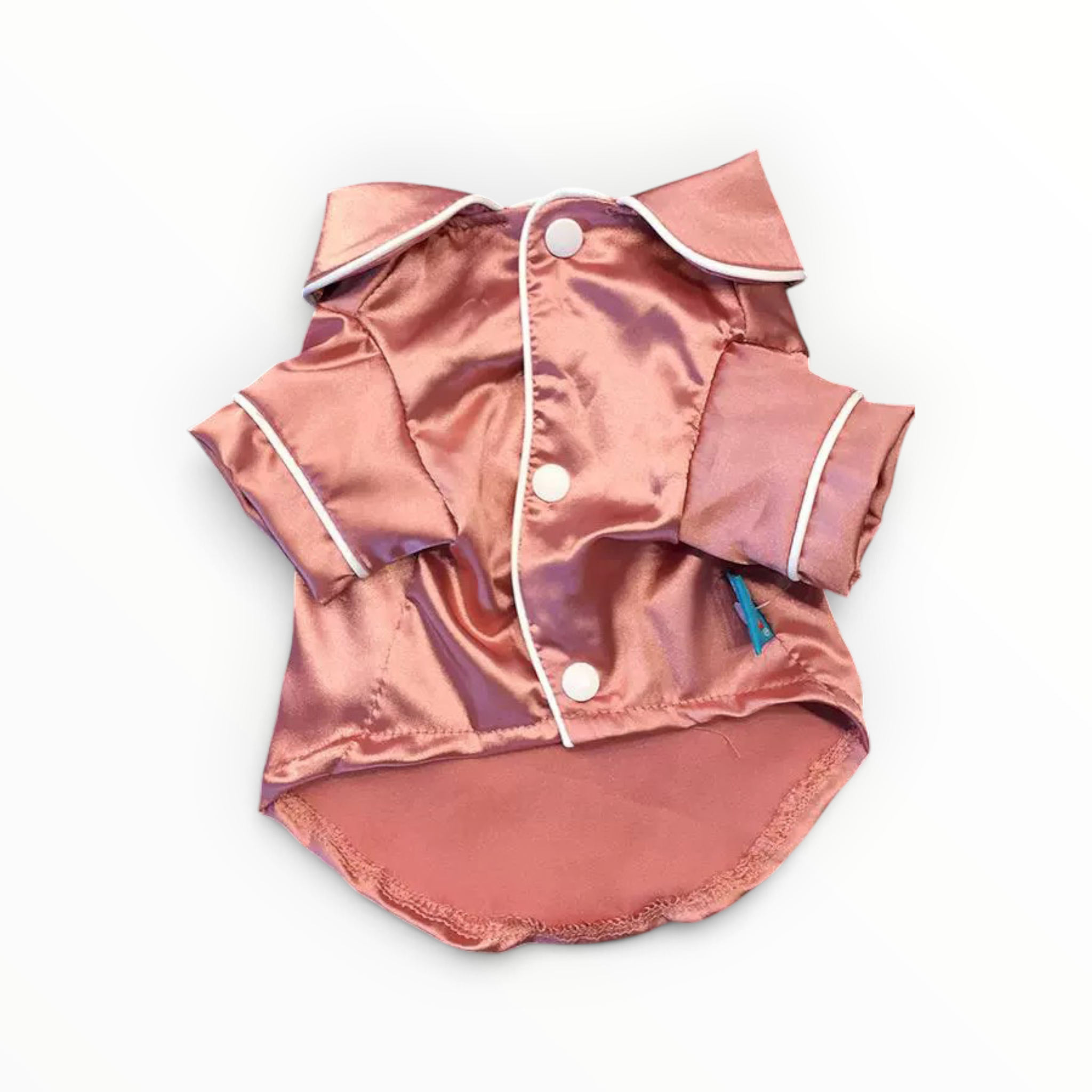 A small satin pet shirt in a metallic rose gold color with white piping and snap buttons, laid flat on a white background.