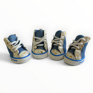 Four miniature high-top baby shoes arranged in a row on a white background. The shoes feature a textured blue mesh upper, a beige faux-leather toe cap with small gold star details, white laces, and a blue and beige sole.
