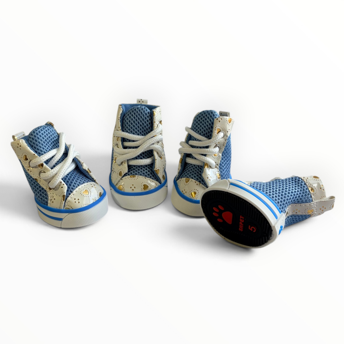 Four small high-top sneakers for pets, shown from multiple angles on a clean white background. The shoes feature a blue mesh upper, beige side panels with gold star details, white laces, and a black outsole with a red paw print and the word 'PET'.