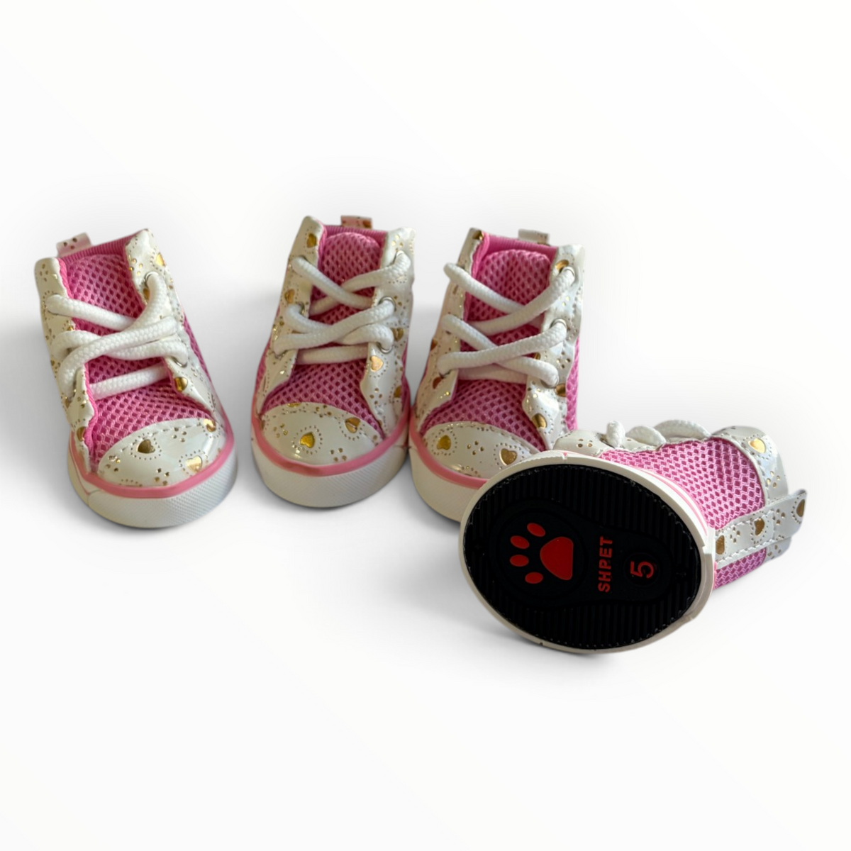 Three pink and white pet high-top shoes with white laces and gold heart details, alongside a black oval insole labeled 'SHIPET 5' with a red paw print, shown on a white background.