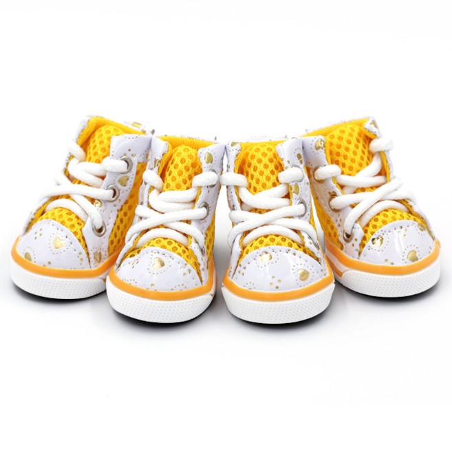 Four baby high-top sneakers in a pair of white and yellow with gold speckles, white laces, and yellow mesh lining, arranged on a white background.