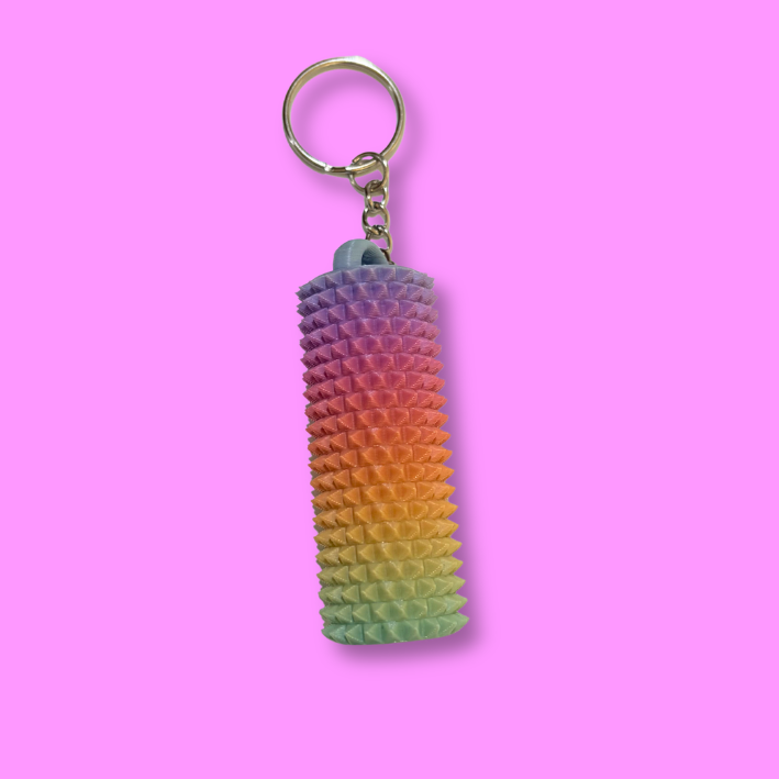 Spiked Sensory Fidget on a keychain on a purple background