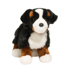 Plush toy dog with black, white, and brown fur on a white background